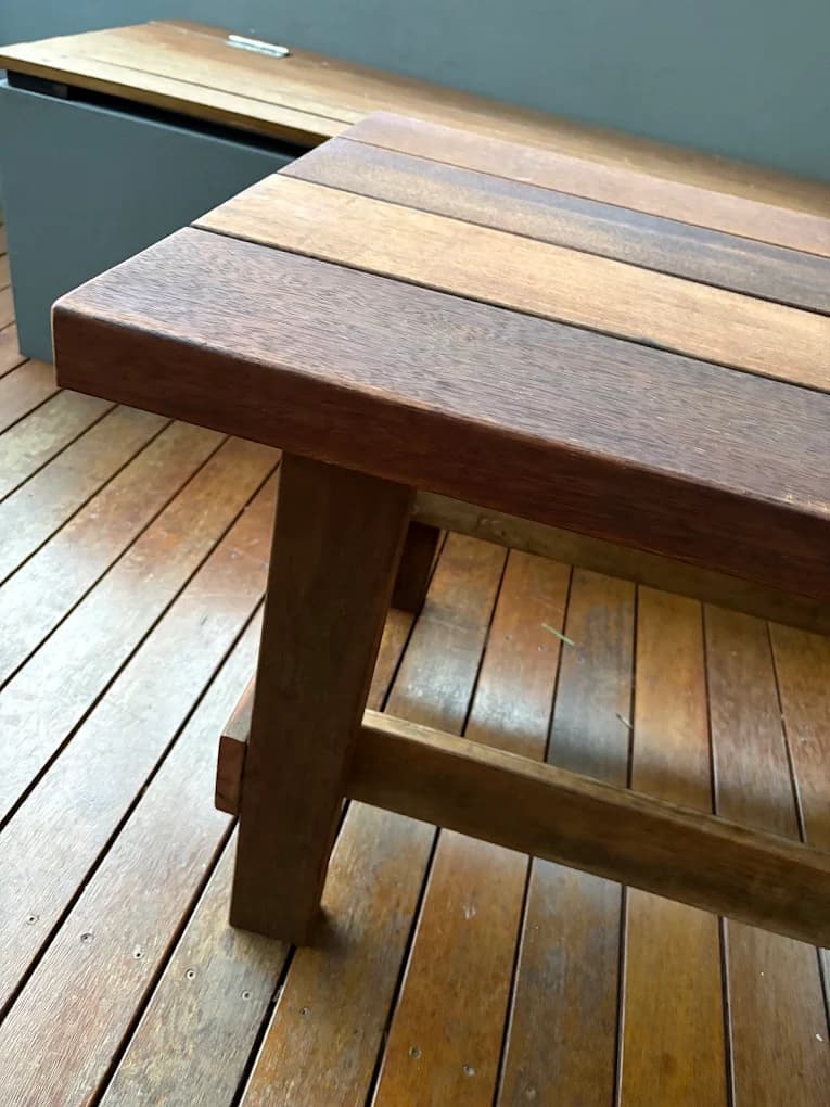 Custom outdoor hardwood table and bench on a timber deck